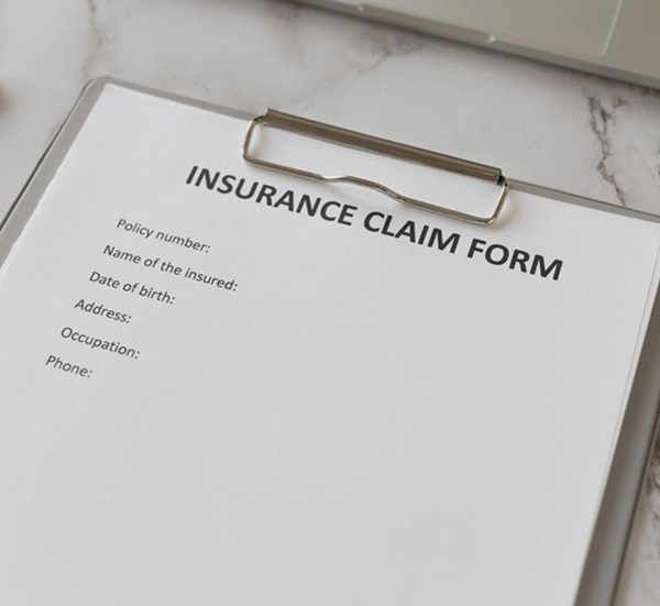 A close-up of an insurance claim form representing Insurance Claims Assistance in India.